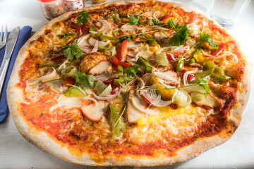 A pizza with Chicken Tikka Butter Masala