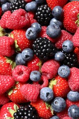 Assortment of fresh ripe berries as background, top view