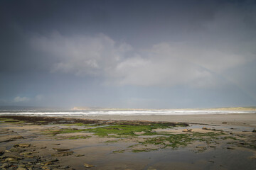 A windy, wet autumnal HDR image of Dunnet bay with Dunnet head in the hazy distance as storm Babet arrives, Caithness, Scotland.