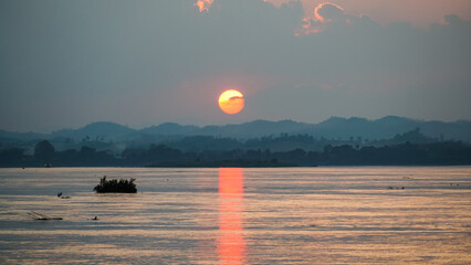 Beautiful sunset on Mekong river and mountain scenery at Chiang Khan, border of Thailand and Laos, Loei province,Thailand. - obrazy, fototapety, plakaty