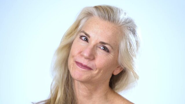 Closeup portrait of happy smiling attractive mature woman naked looking at camera. Advertising of body care spa concept.