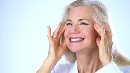 Beautiful mature old woman smiling wonder about face lift, cosmetic plastic surgery, look at camera, healthy skin natural makeup skincare routine anti aging lifting wrinkles beauty self love.