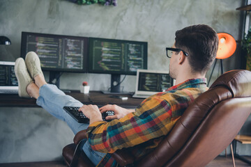 Full body rear portrait of skilled cyber security expert sit chair keyboard typing coding loft interior office inside