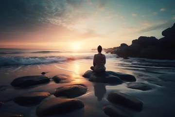Gartenposter Person sitting on the stones meditates on the beach near the water © marikova