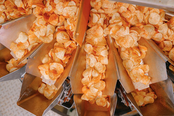 Potato chips production line at food industrial plant. Filling machines for snacks, top view