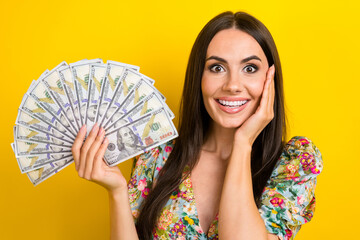 Photo of impressed astonished girl dressed flower print blouse hold palm on cheekbone win lottery isolated on yellow color background