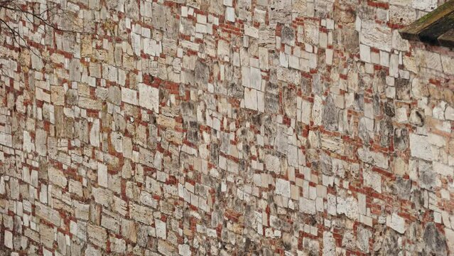 Old beige stone wall background texture close up of medieval castle