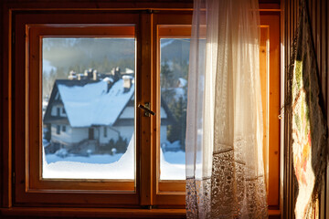 Beautiful view from window on winter village with  snow in sunny day. Enjoying winter weather - obrazy, fototapety, plakaty