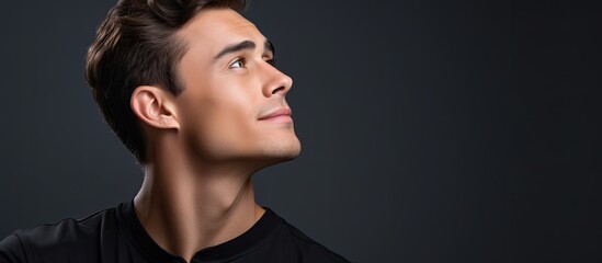 Young man in profile thinking with hand on chin