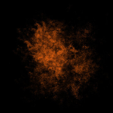 Orange color powder explosion isolated on black background. Royalty high-quality free stock photo image Freeze motion of Orange powder exploding. Colorful dust explode. Paint Holi, dust particles spla