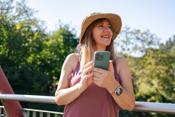 Adult woman smiling looking at smart phone