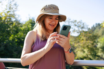 Adult woman smiling looking at smart phone