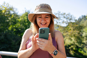 Adult woman smiling looking at smart phone