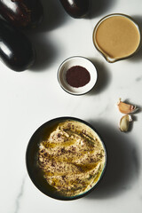 Mutabal or Moutabal - Middle Eastern dip made from roasted eggplants with tahini, garlic and lemon juice. It's creamy, smoky, and tangy.