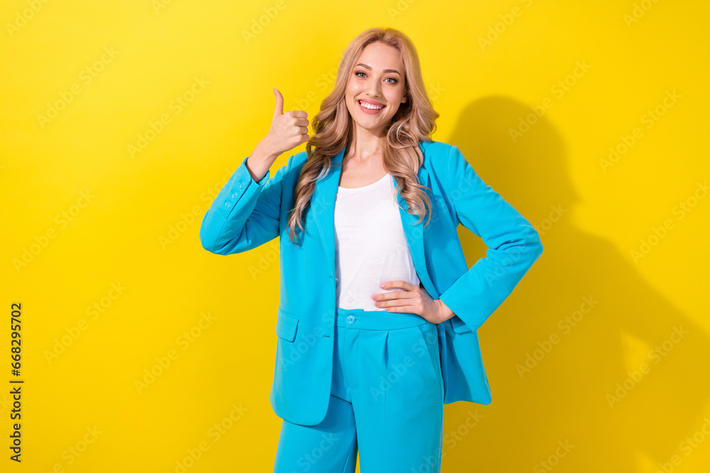 Poster portrait of cheerful lovely girl toothy smile hand finger demonstrate thumb up approval isolated on 