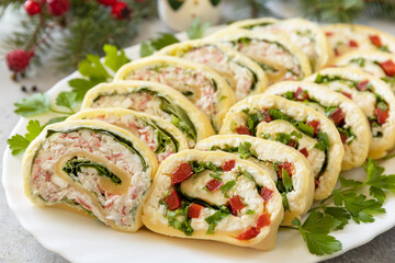 Creative appetizers christmas. Cheese rolls with crab sticks, cream cheese, eggs and cream cheese, sweet pepper, greens.