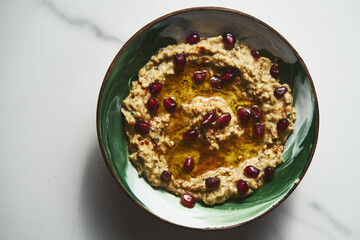 Baba ganoush. A smoky Middle Eastern dip made from roasted eggplants, blended with tahini, lemon juice with garlic and olive oil. often garnished with parsley and served with pita bread.