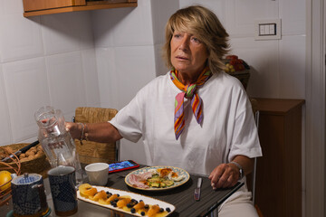 Beautiful woman in the kitchen having healthy food for breakfast