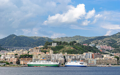 Ferry boats at the harbor of Messina with city in the background