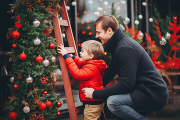 Obraz premium dad and son decorating Christmas tree outdoor