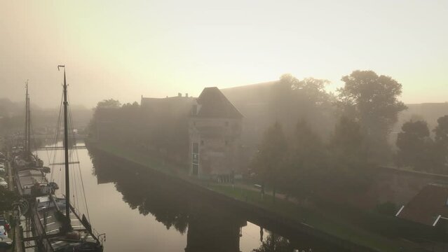 View on the Thorbeckegracht in Zwolle, Overijssel The Netherlands, during a beautiful misty autumn morning day classic sailing freight ships in the canal.