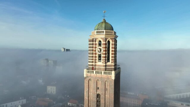 The Peperbus tower of the The Roman Catholic Onze Lieve Vrouwe ten Hemelopneming-basilica church in Zwolle rising up above the fog.