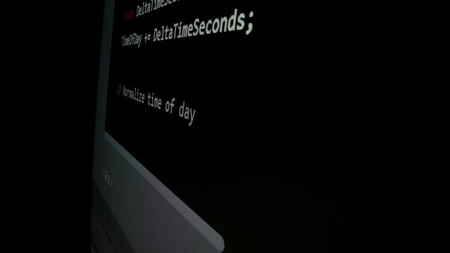 Closeup macro shot movement of coding script moving across LED screen with real-time AI-generated typing, showcasing advanced AI learning in optimization, debug and coding for software development.