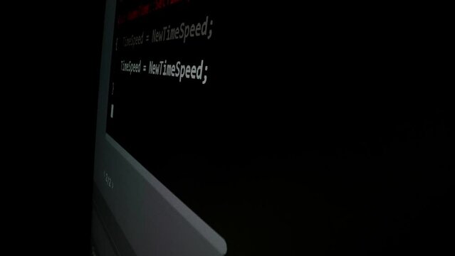 Closeup macro shot movement of coding script moving across LED screen with real-time AI-generated typing, showcasing advanced AI learning in optimization, debug and coding for software development.