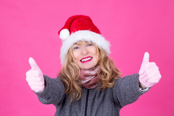 woman in santa claus cap doing ok with finger