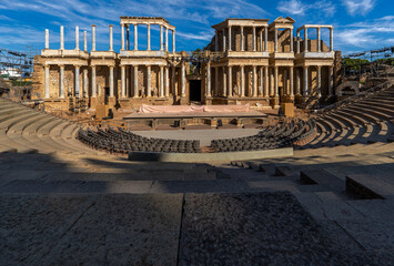 Complete view from below of the floor of the Roman Theater of Mérida with the scaffolding, spotlights, stage and chairs placed under the stands prepared for International Classical Theater Festival - obrazy, fototapety, plakaty