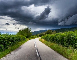 Fototapeta na wymiar Green Wilderness Road Journey under Stormy Skies