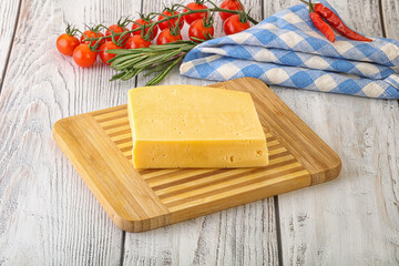 Piece of natural organic cheese over board