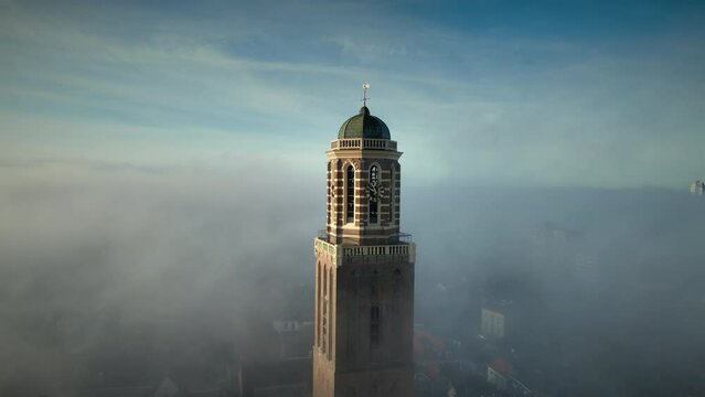 The Peperbus tower of the The Roman Catholic Onze Lieve Vrouwe ten Hemelopneming-basilica church in Zwolle rising up above the fog.