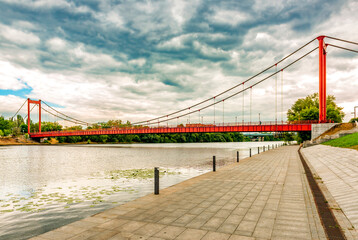 The embankment of the Sura River in the city of Penza with a view of the suspension bridge across the river