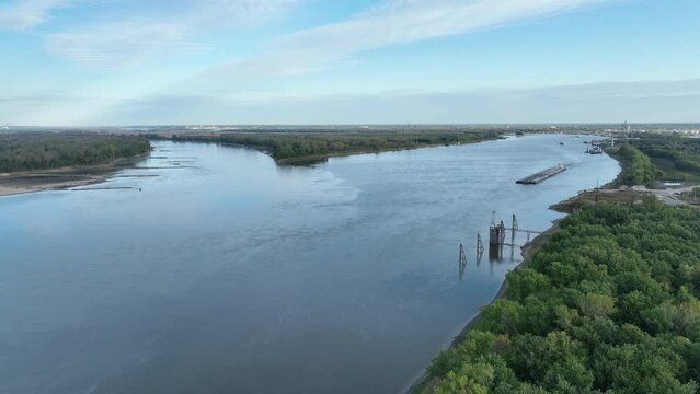 towboat with barges on the Mississippi River at confluence with the Missouri River below Alton, IL - aerial view