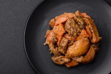 Delicious vegetable stew of potatoes, beef meat, mushrooms, carrots, salt, spices and herbs