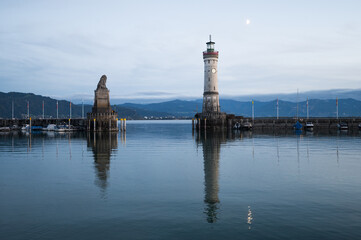 The well-known harbour entrance with its Bavarian lion and white lighthouse is set, Alps and Lake Constance, lindau