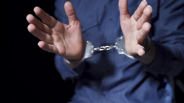 Prison, guilty man, handcuffs.