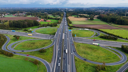 Aerial drone view road junction. Clover roundabout view from above. Car traffic on autobahn...