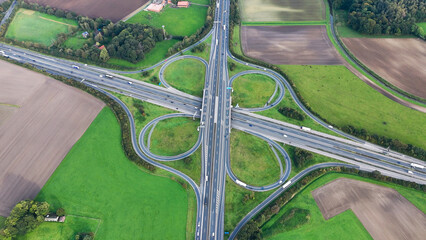 Aerial drone view road junction. Clover roundabout view from above. Car traffic on autobahn...