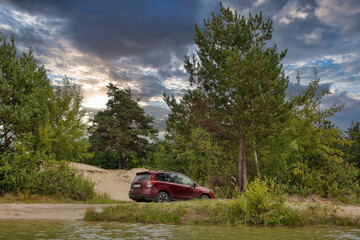 Red SUV car in a sand pit.