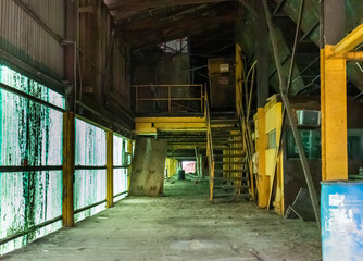 Interior of abandoned distribution warehouse with industrial equipment