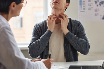 Close up of man scratching neck suffering from allergies or skin condition consulting with...