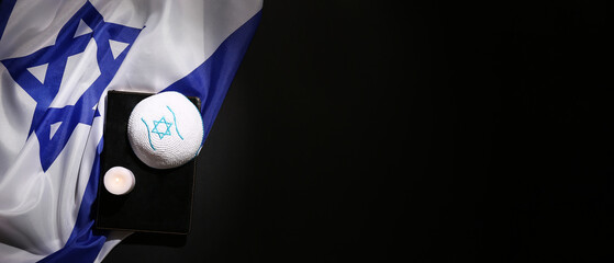 Torah, Jewish hat, burning candle and flag on dark background with space for text. Israel-Hamas war