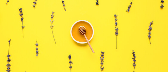Bowl of sweet lavender honey, dipper and many flowers on yellow background, top view