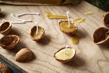 Handmade production of Christmas candles from bees wax and walnut shells