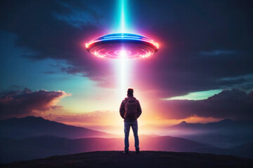 A huge flying saucer hovers in the evening sky, clouds and mountains, a bright glowing neon beam. The figure of a man with a backpack against the background of a spaceship.