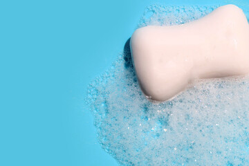 Yellow sponge with bubbles on blue background