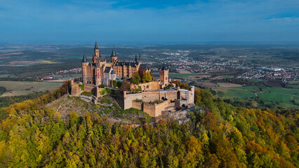 Aerial drone view of medieval Hohenzollern castle on top of hill in autumn, Baden-Wurttemberg, Germany.