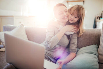 Little girl hugging her mother at home
